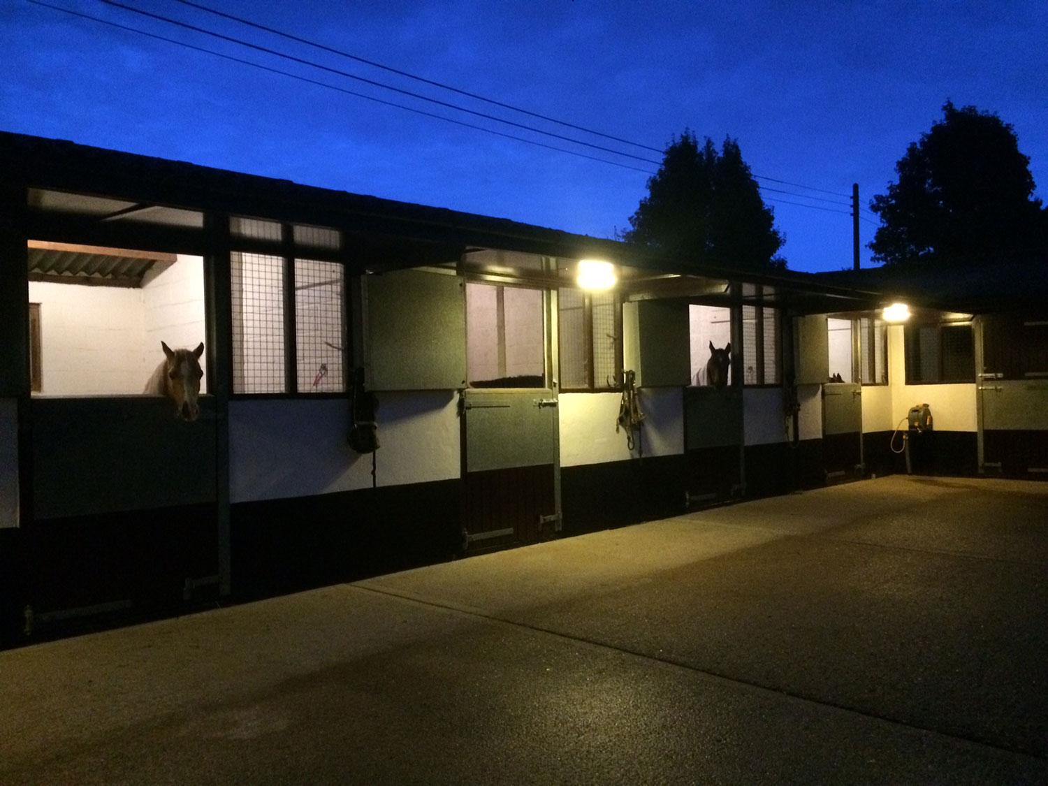 The yard and stables well lit at night